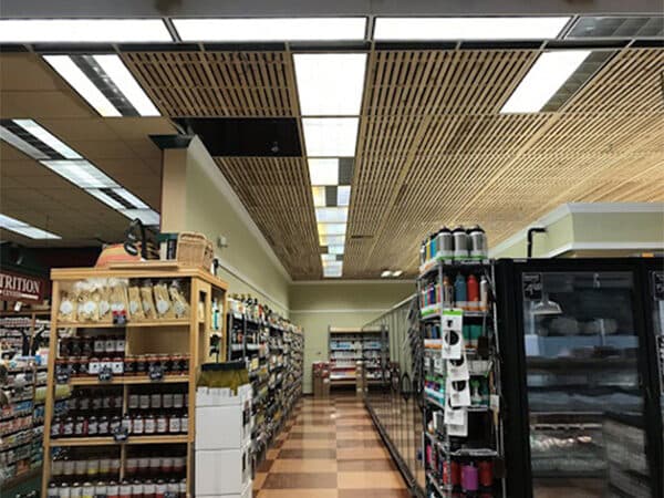 Retail aisle beneath wood ceiling features and lighting