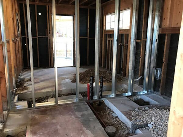 Interior wall framing and utility rough-ins during construction