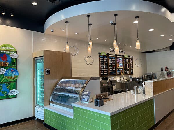 Finished dessert shop counter with display case and menu boards