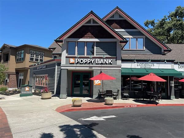 Poppy Bank branch beside neighboring storefronts